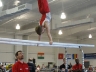 Coaches looking on during Justus\' p-bar routine